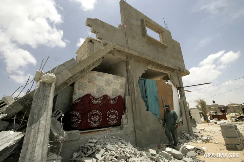 A Palestinian man inspects his belongings after his house was demolished by Hamas security forces in Rafah in the southern Gaza Strip on May 19, 2010. Hamas Islamists ruling the Gaza Strip have been demolishing Palestini...