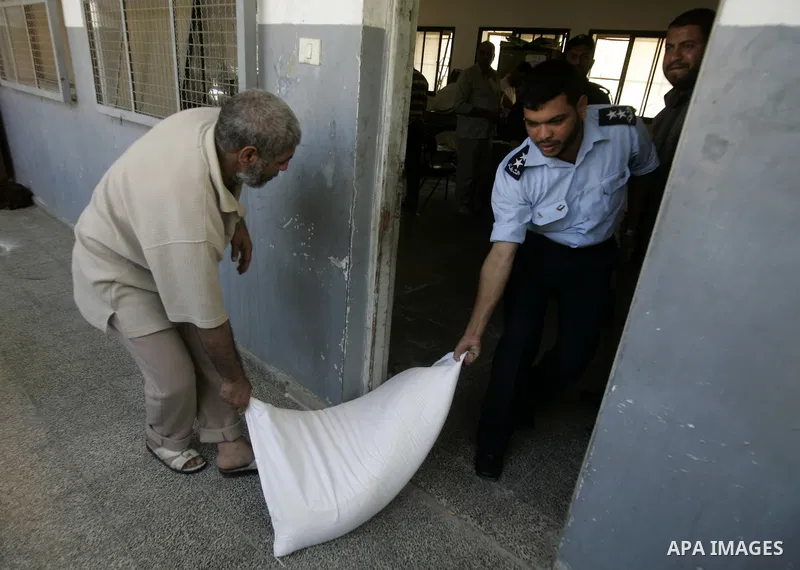 A Palestinian prisoner receives a sack of flour at a Hamas-run prison in Rafah on the southern Gaza Strip May 20, 2010. The Hamas ministry of social affairs said it began distributing food supplies among prisoners to be...