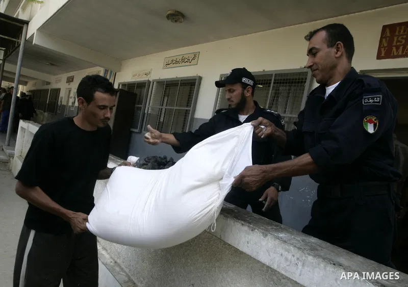 A Palestinian prisoner receives a sack of flour at a Hamas-run prison in Rafah on the southern Gaza Strip May 20, 2010. The Hamas ministry of social affairs said it began distributing food supplies among prisoners to be...
