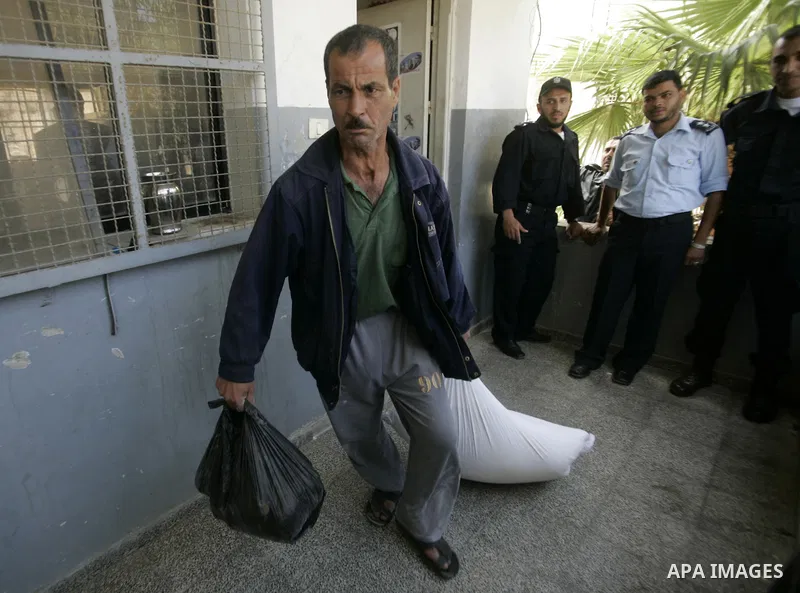 A Palestinian prisoner receives a sack of flour at a Hamas-run prison in Rafah on the southern Gaza Strip May 20, 2010. The Hamas ministry of social affairs said it began distributing food supplies among prisoners to be...