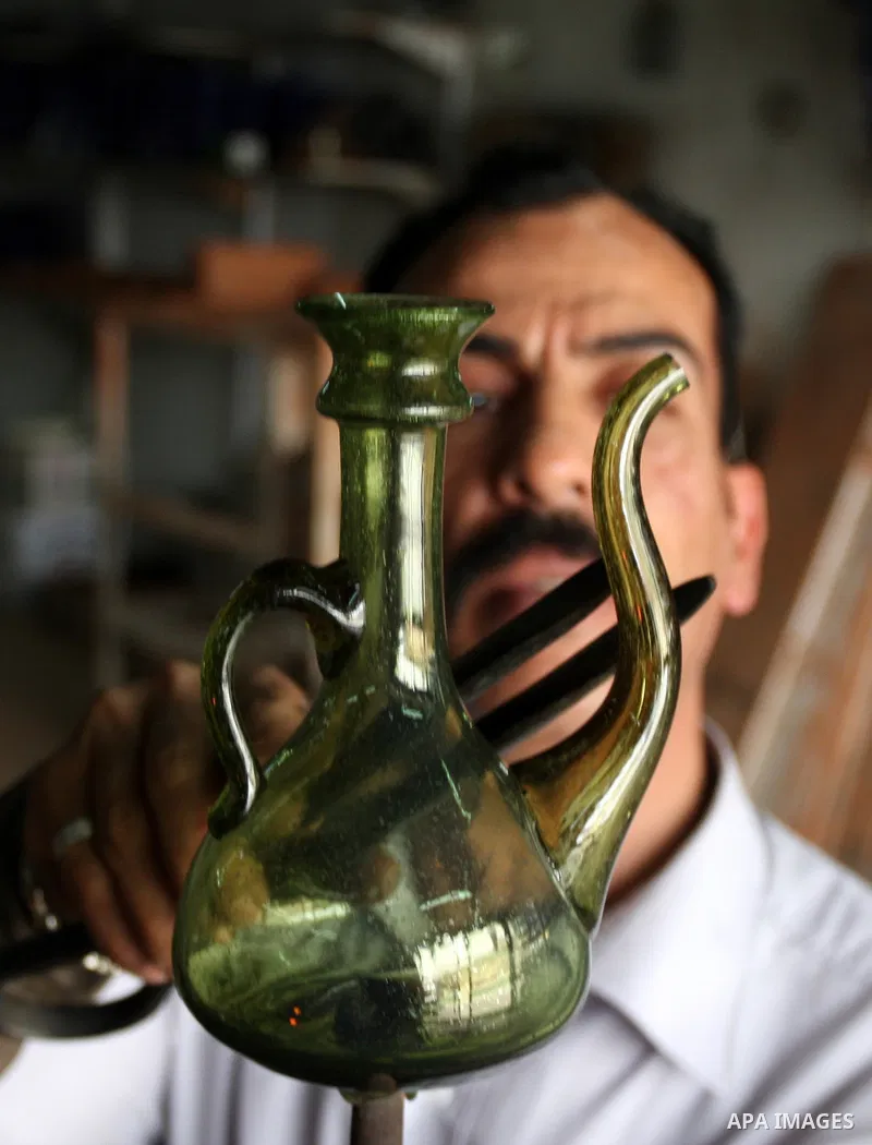 Palestinian worker makes a different types of glasses in AL-Salam factory in the West Bank city of Hebron on May 21, 2010. Glass has been a traditional industry in Hebron for over 600 years but as a result of the increas...