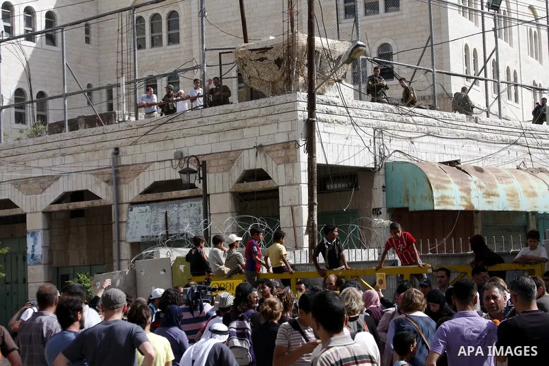 Israeli left-wing activists and Palestinians protest against Jewish settlements and Shuhada street closing near Beit Romano settlement in the city center of the West Bank city of Hebron on May 22, 2010. Photo by Mamoun W...