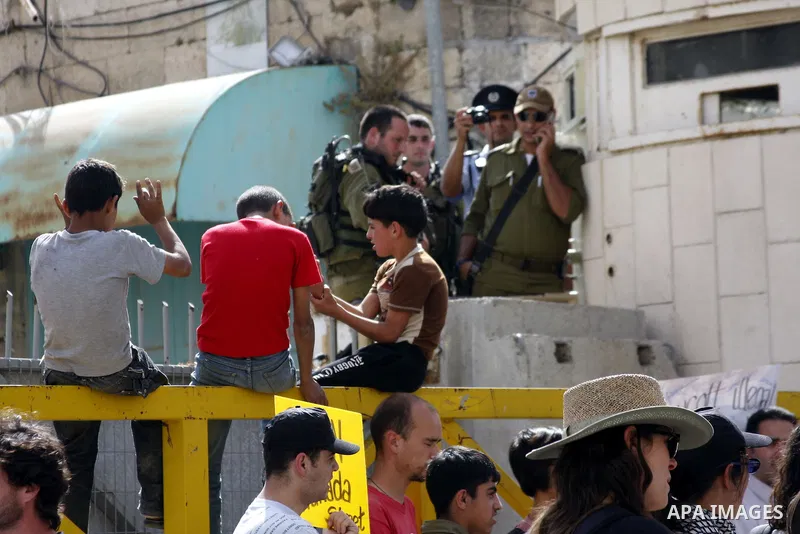 Israeli left-wing activists and Palestinians protest against Jewish settlements and Shuhada street closing near Beit Romano settlement in the city center of the West Bank city of Hebron on May 22, 2010. Photo by Mamoun W...