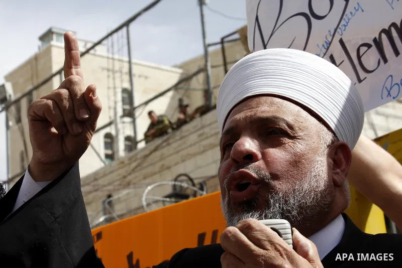Palestinian Grand Mufti, Tayser Al-Tamimi takes part in a protest against Jewish settlements and Shuhada street closing near Beit Romano settlement in the city center of the West Bank city of Hebron on May 22, 2010. Phot...