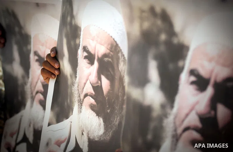 Palestinian Hamas supporters carry pictures of Sheikh Raed Salah during anti-Israeli protest at the port of Gaza City on May 31, 2010. At least 10 activists were killed in an Israeli naval takeover on Monday of a Gaza-bo...