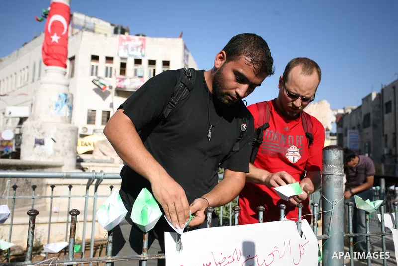 Palestinian youths lay paper ships at Al-Manarah square in the West Bank town of Ramallah, on 31 May 2010. Abbas condemned the long-anticipated Israeli takeover of six ships carrying humanitarian aid for the Gaza Strip t...