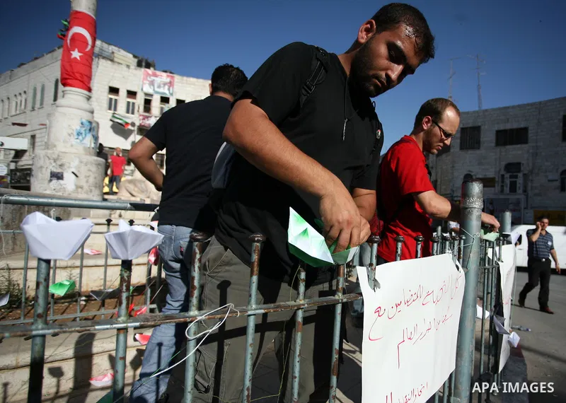 Palestinian youths lay paper ships at Al-Manarah square in the West Bank town of Ramallah, on 31 May 2010. Abbas condemned the long-anticipated Israeli takeover of six ships carrying humanitarian aid for the Gaza Strip t...