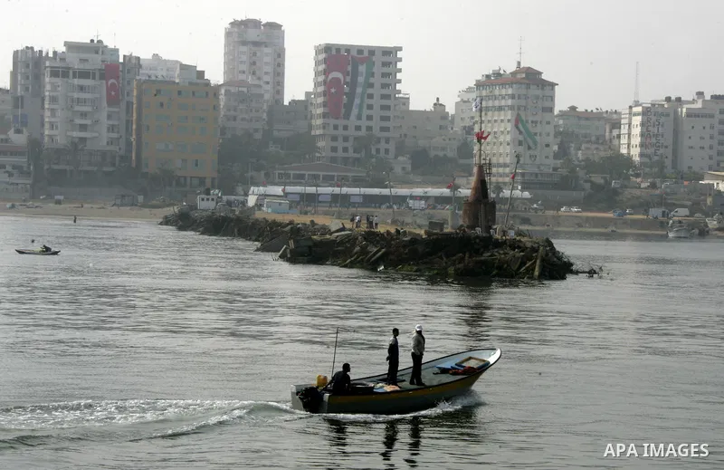 Palestinian fishermen ride a boat in the port of Gaza City on May 31, 2010. At least 10 people were killed in an Israeli Navy raid on a fleet of aid ships, most of them Turkish nationals, according to a Turkish charity i...