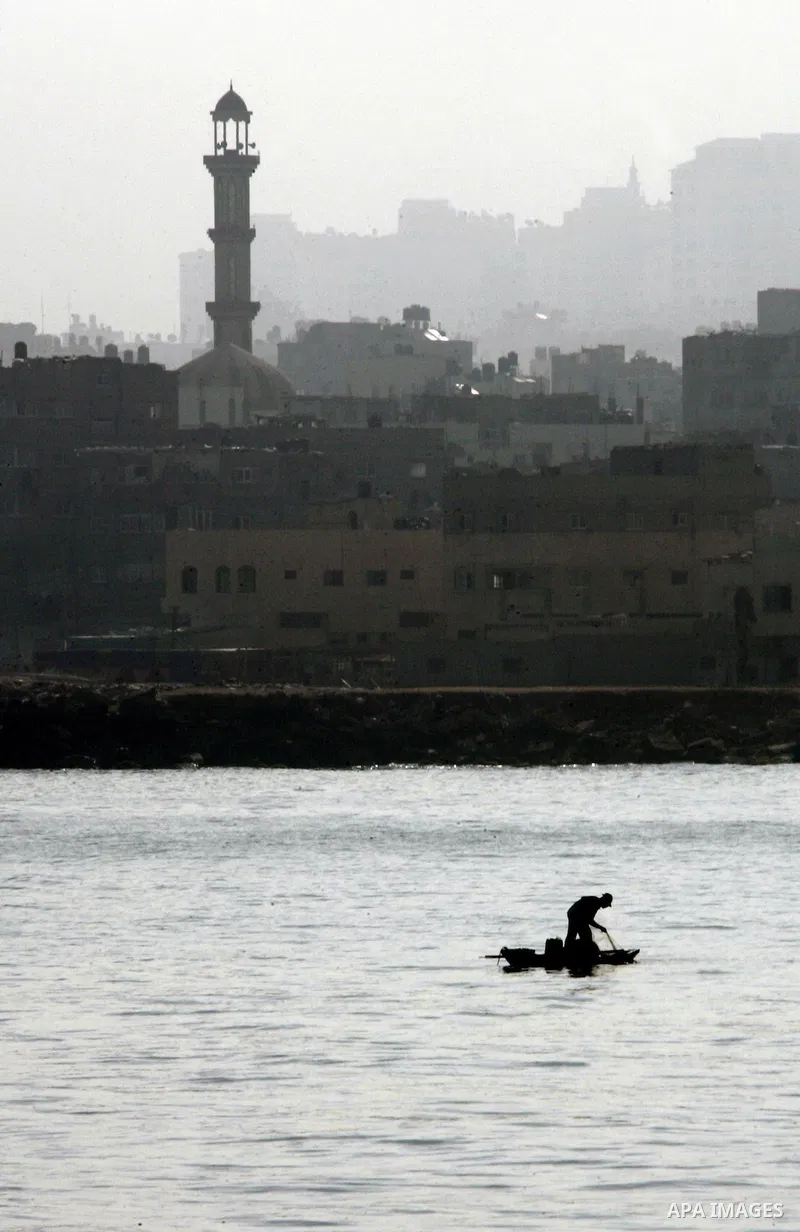 A Palestinian fisherman rides a boat in the port of Gaza City on May 31, 2010. At least 10 people were killed in an Israeli Navy raid on a fleet of aid ships, most of them Turkish nationals, according to a Turkish charit...