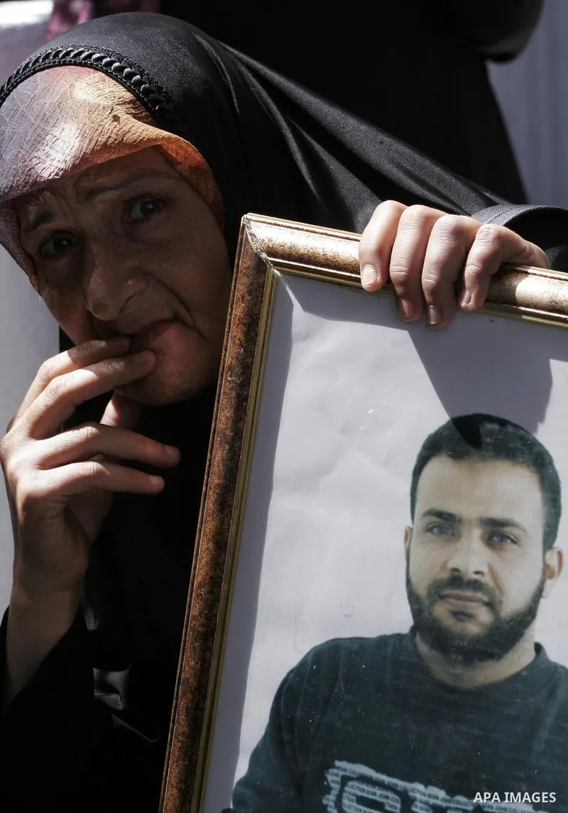 Palestinian women hold pictures of jailed relatives during a protest calling for the release of Palestinian prisoners from Israeli jails at the Red Cross office in Gaza City on June 7,2010. Photo by Yousef Deeb