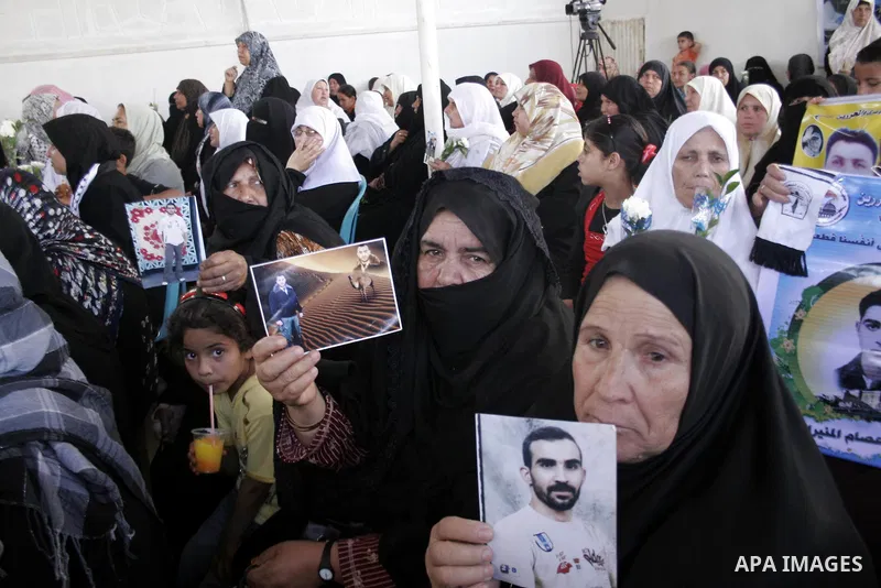 Palestinian women hold pictures of jailed relatives during a protest calling for the release of Palestinian prisoners from Israeli jails at the Red Cross office in Gaza City on June 7,2010. Photo by Yousef Deeb