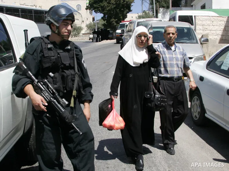 Israeli soldiers stand guards as an Israeli bulldozer destroy a Palestinian family house in east Jerusalem neighborhood of Silwan on June 15,2010, where Palestinian houses are threatened to be demolished by the Israeli c...