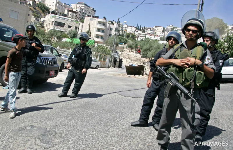 Israeli soldiers stand guards as an Israeli bulldozer destroy a Palestinian family house in east Jerusalem neighborhood of Silwan on June 15,2010, where Palestinian houses are threatened to be demolished by the Israeli c...