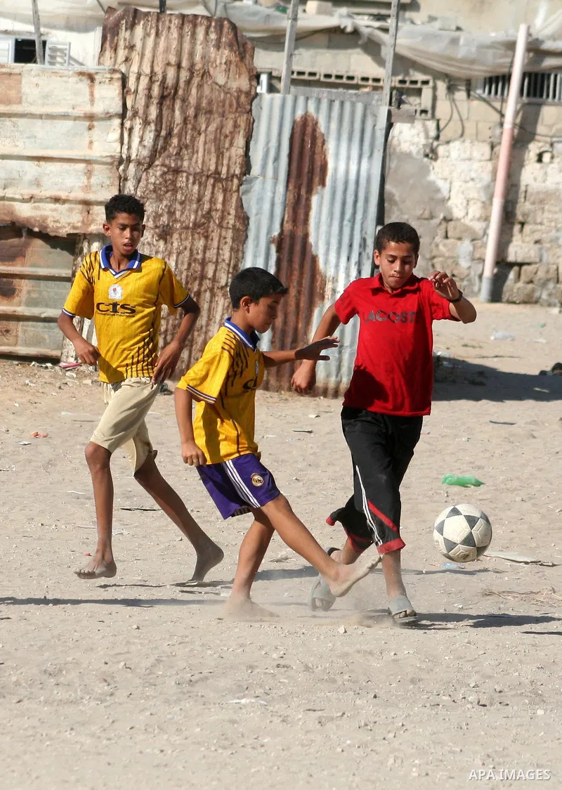 Palestinian boys play football in Gaza city on June 15,2010, in the fifth day of starting the World Cup 2010 in South Africa. Photo by Ashraf Amra