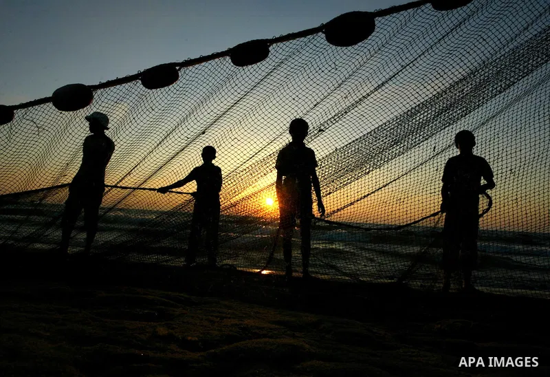 Palestinian fishermen prepare their nets on the beach in Deir al-Balah as the sun sets over the central of Gaza Strip on June 15, 2010. Photo by Ashraf Amra