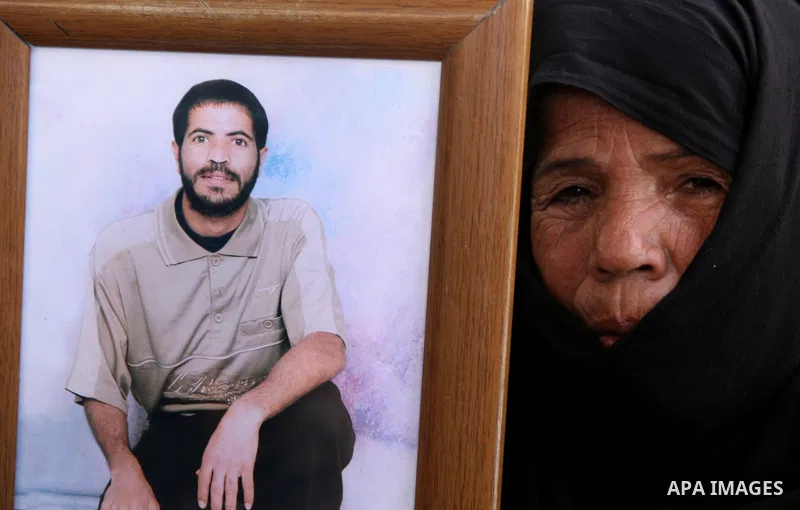 Palestinian women and children hold pictures of jailed relatives during a protest calling for the release of Palestinian prisoners from Israeli jails at the Red Cross office in Gaza City on June 21,2010. Photo by Ali Jad...