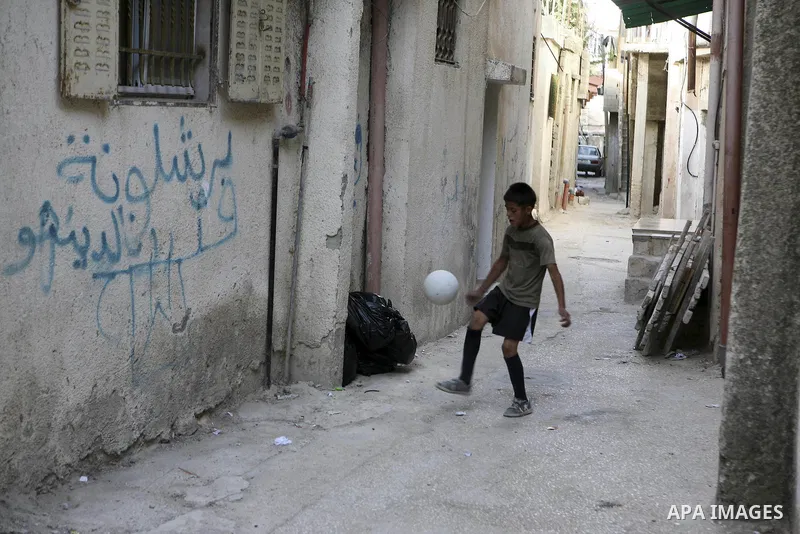 Palestinian children play at Al-Amari refugee camp in the West Bank town of Ramallah, Monday, June 21, 2010. The United Nations High Commission for Refugees marks June 20 as World Refugee Day. Photo by Eyad Jadallah