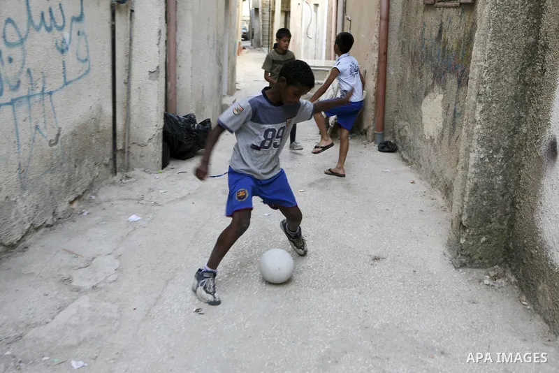 Palestinian children play at Al-Amari refugee camp in the West Bank town of Ramallah, Monday, June 21, 2010. The United Nations High Commission for Refugees marks June 20 as World Refugee Day. Photo by Eyad Jadallah