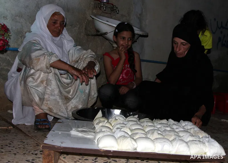 A Palestinian family of Abu Sultan member makes cheese from the milk of the goats in their house after Israeli settlers stole 120 sheep in Salem village near the West Bank city of Nablus on June 22, 2010. Abu Sultan feed...
