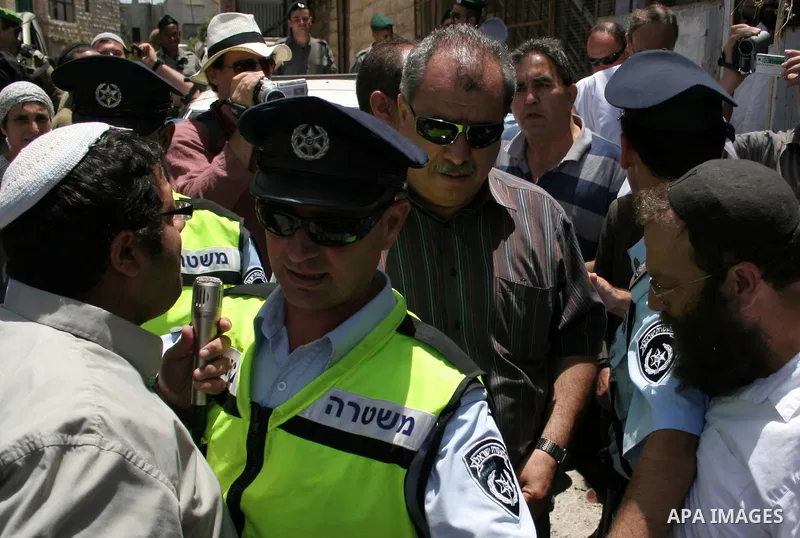 Arab Knesset members argue with the Jewish settlers as they visit Shuhada street and Palestinian families living close to Jewish settlers in the divided West Bank city of Hebron on June 23, 2010. Photo by Mamoun Wazwaz