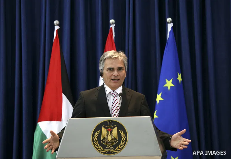 Austrian Chancellor Werner Faymann and Palestinian President Mahmoud Abbas (not seen) hold a joint news conference in the West Bank city of Ramallah on June 24, 2010. Photo by Eyad Jadallah