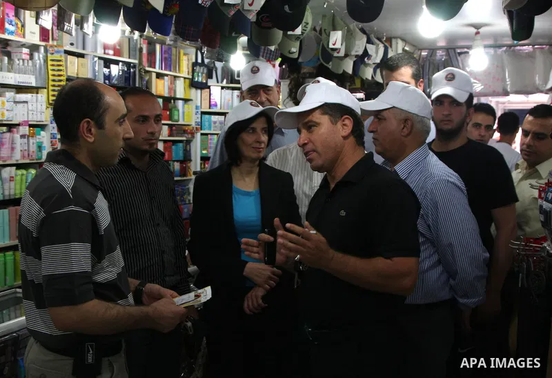 Palestinian volunteers attend a rally as they distribute a guidebook to boycott the settlements products in the West Bank city of Nablus, Monday June 28, 2010. The Palestinian authority launched a campaign of boycotting...