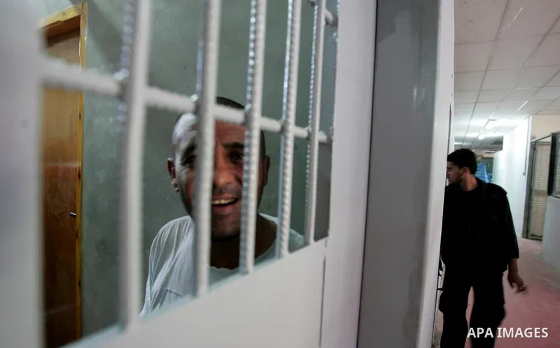 Palestinian police watch inmates in a Hamas-operated new prison in the southern of Gaza strip town of Khan Yunis on June 28,2010.The detention facility was opened after the main prison was destroyed during Israel's 22-da...