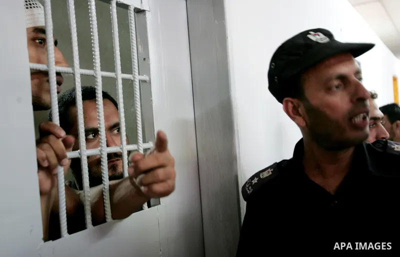 Palestinian police watch inmates in a Hamas-operated new prison in the southern of Gaza strip town of Khan Yunis on June 28,2010.The detention facility was opened after the main prison was destroyed during Israel's 22-da...