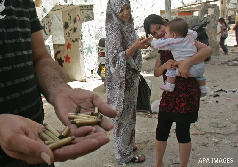 Palestinians collect empty tear gas canisters fired by Israeli soldiers after clashes with Palestinian protesters in the Arab east Jerusalem neighbourhood of Silwan on June 28, 2010. Photo by Mahfouz Abu Turk