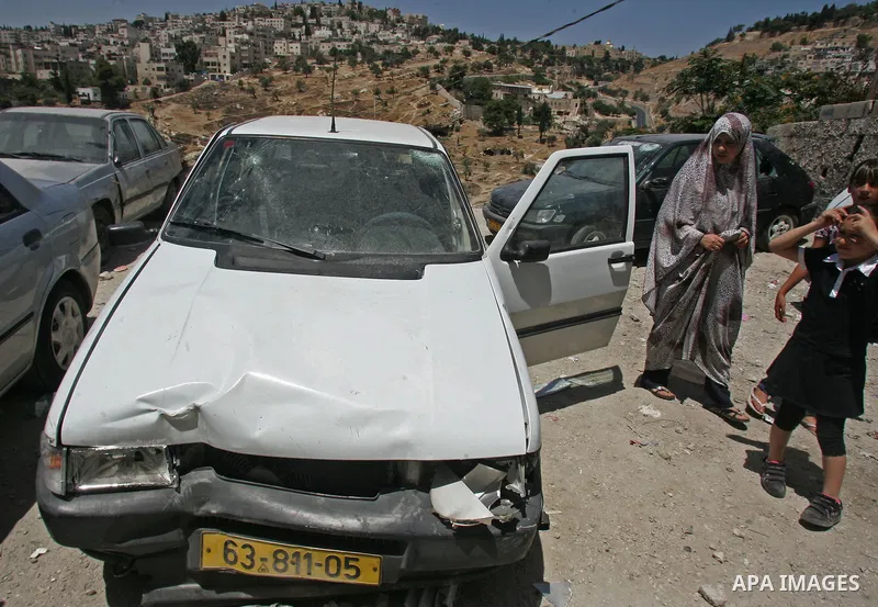 Palestinians inspect the damage in cars by Israeli soldiers after clashes with Palestinian protesters in the Arab east Jerusalem neighbourhood of Silwan on June 28, 2010. Photo by Mahfouz Abu Turk