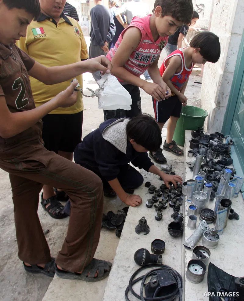 Palestinians collect empty tear gas canisters fired by Israeli soldiers after clashes with Palestinian protesters in the Arab east Jerusalem neighbourhood of Silwan on June 28, 2010. Photo by Mahfouz Abu Turk