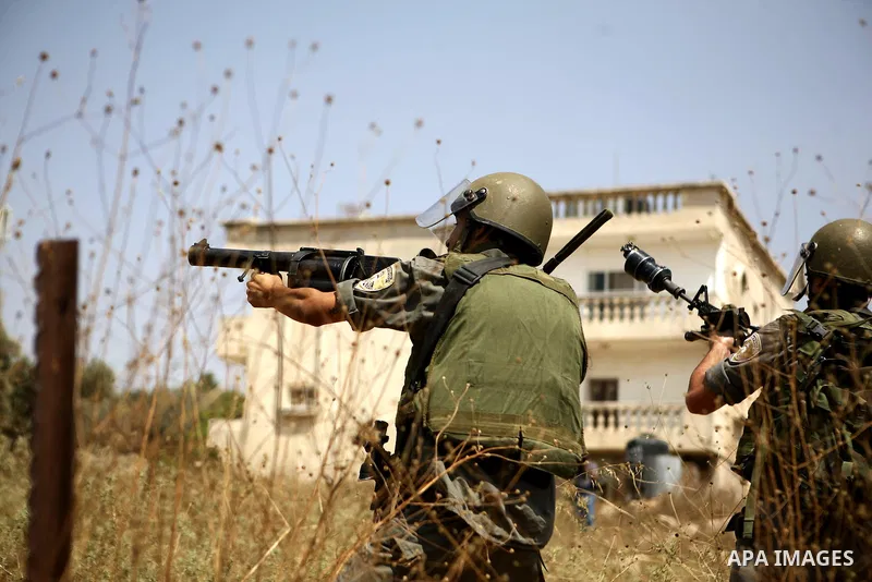 An Israeli soldier prepares to fire tear gas canister during a protest by Palestinian and foreign protesters against the expansion of the Israeli settlements at Nabi Salah village near the West Bank City of Ramallah, on...