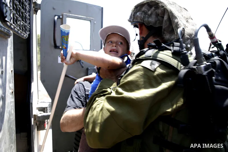 Israeli soldiers arrest a protester during a protest against the expansion of the Israeli settlements at Nabi Salah village near the West Bank City of Ramallah, on 09 July 2010. Photo by Eyad Jadallah