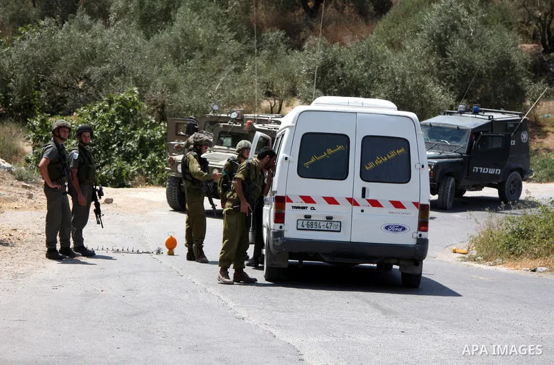 Israeli soldiers check a Palestinian car at a military checkpoint in the village of Iraq Burin near the West Bank city of Nablus on July 10,2010. Photo by Wagdi Eshtayah