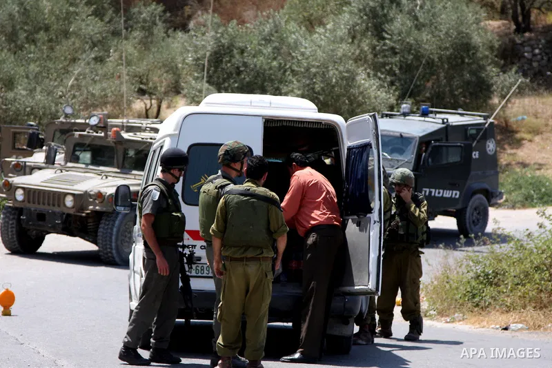 Israeli soldiers check a Palestinian car at a military checkpoint in the village of Iraq Burin near the West Bank city of Nablus on July 10,2010. Photo by Wagdi Eshtayah