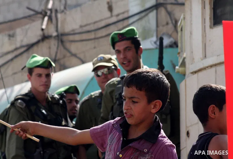 Israeli, foreign and Palestinians activists protest against the building of Jewish settlement and against the Jewish settlers living in the Palestinian territories, as they gather at the Israeli manned Beit Romano settle...