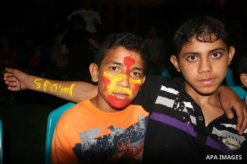 Palestinian orphans watch the final match of the World Cup between Spain and the Netherlands being played in South Africa in Gaza city on July 11,2010. Photo by Mohammed Asad