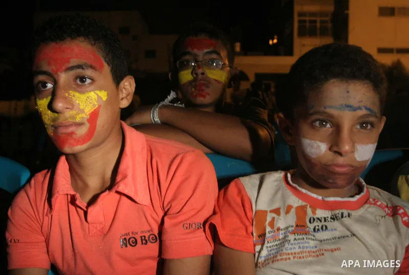 Palestinian orphans watch the final match of the World Cup between Spain and the Netherlands being played in South Africa in Gaza city on July 11,2010. Photo by Mohammed Asad