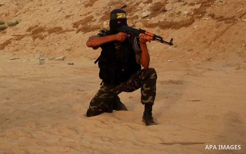 A masked Palestinian militant from Islamic Jihad takes part in a training exercise in Gaza City on July 15,2010. Photo by Yousef Deeb