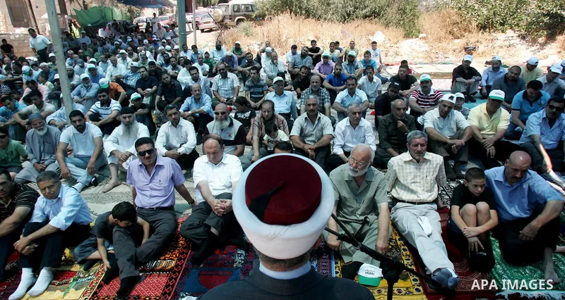 Palestinians pray in the Red Cross yard during the Friday prayer in East Jerusalem , Friday 16 July 2010, in solidarity with PLC members and former Palestinian minister Ahmad Atwon, Mohammad Totah and Khalid Abu Arfeh. A...
