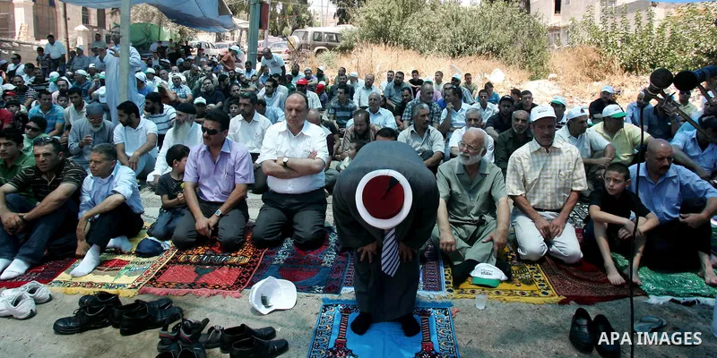 Palestinians pray in the Red Cross yard during the Friday prayer in East Jerusalem , Friday 16 July 2010, in solidarity with PLC members and former Palestinian minister Ahmad Atwon, Mohammad Totah and Khalid Abu Arfeh. A...