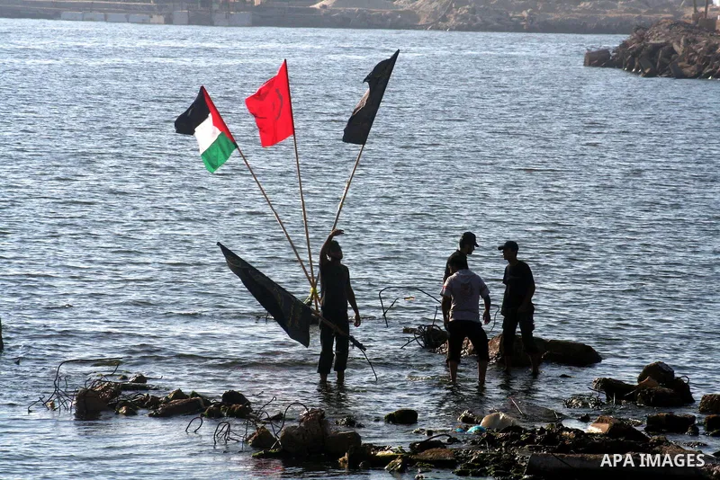 Palestinian supporters of Islamic Jihad movement hold a rally in solidarity with the nine Turkish activists who were killed aboard Gaza-bound aid flotilla in May after Israeli navy stormed it, at Gaza seaport in Gaza cit...