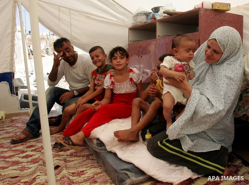 Palestinian family sit in a tent on the rubbles of their home in the Arab neighborhood of Beit Hanina in occupied east Jerusalem on July 17,2010 after Israeli army bulldozers destroyed their home. Al Rajabi family which...