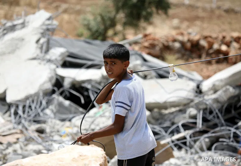 A Palestinian child stands on the rubble of a house in the West Bank village of Lubban al-Gharbia on July 21, 2010 after Israeli forces demolished two houses and four shops that were built without the army's permit near...