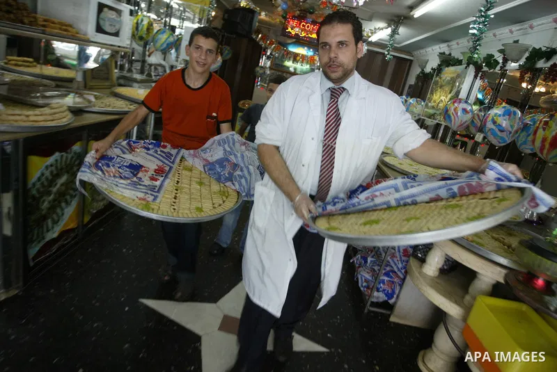 A Palestinian vendor displays sweets in his shop for the families of general secondary certificate students in Gaza city on July 22,2010. The Ministry of Education in Gaza Strip and the West Bank announced the results to...