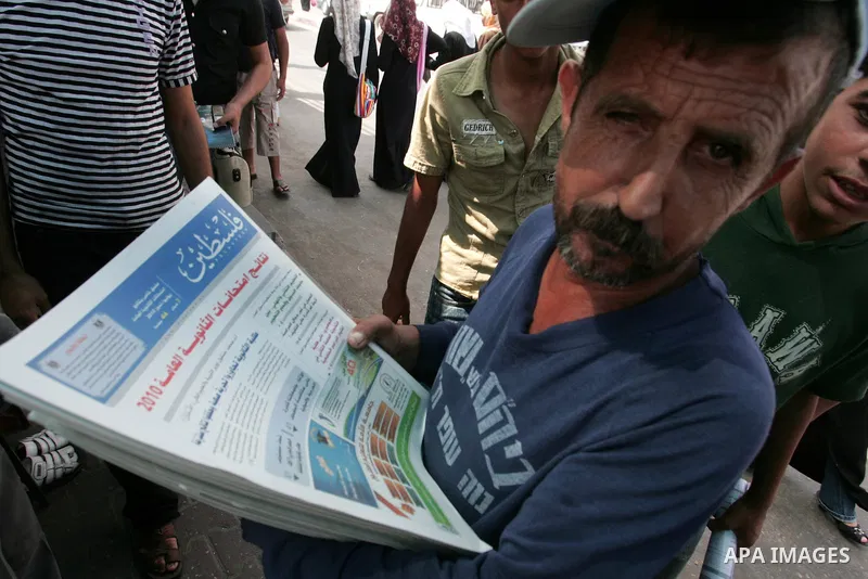A Palestinian man sells newspapers bringing the results of high school exams, or "Tawjihe", in the southern Gaza Strip town of Rafah on July 22,2010. Photo by Khaled Khaled