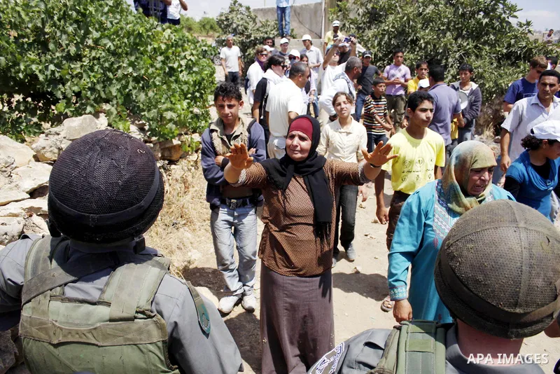 Israeli soldiers argue with Palestinian protesters during a demonstration against Israel's controversial separation barrier in the village of Beit Omar near Jewish settlement of Karmi zur near the West Bank city of Hebro...