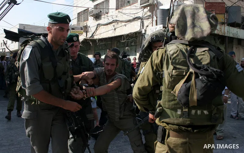 Israeli soldiers arrest a foreign demonstrator during the weekly protest against the closing of Al-Shuhada Street in the West Bank old city of Hebron on July 24,2010. Palestinians, Israelis and International peace activi...