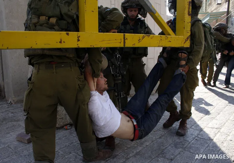 Israeli soldiers arrest a foreign demonstrator during the weekly protest against the closing of Al-Shuhada Street in the West Bank old city of Hebron on July 24,2010. Palestinians, Israelis and International peace activi...