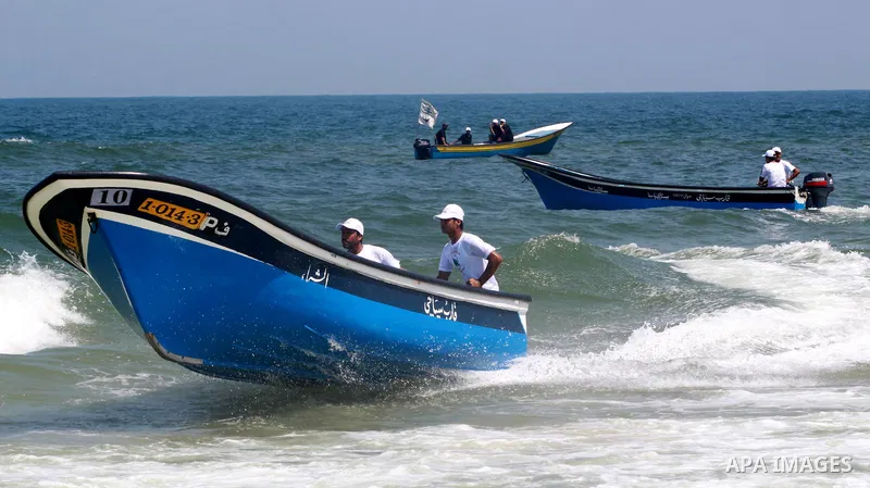 Palestinian men ride their boats during a race near Gaza seaport on July 26,2010. Palestinians participate in the boats race for the first time in Gaza Strip. Photo by Mohammed Asad
